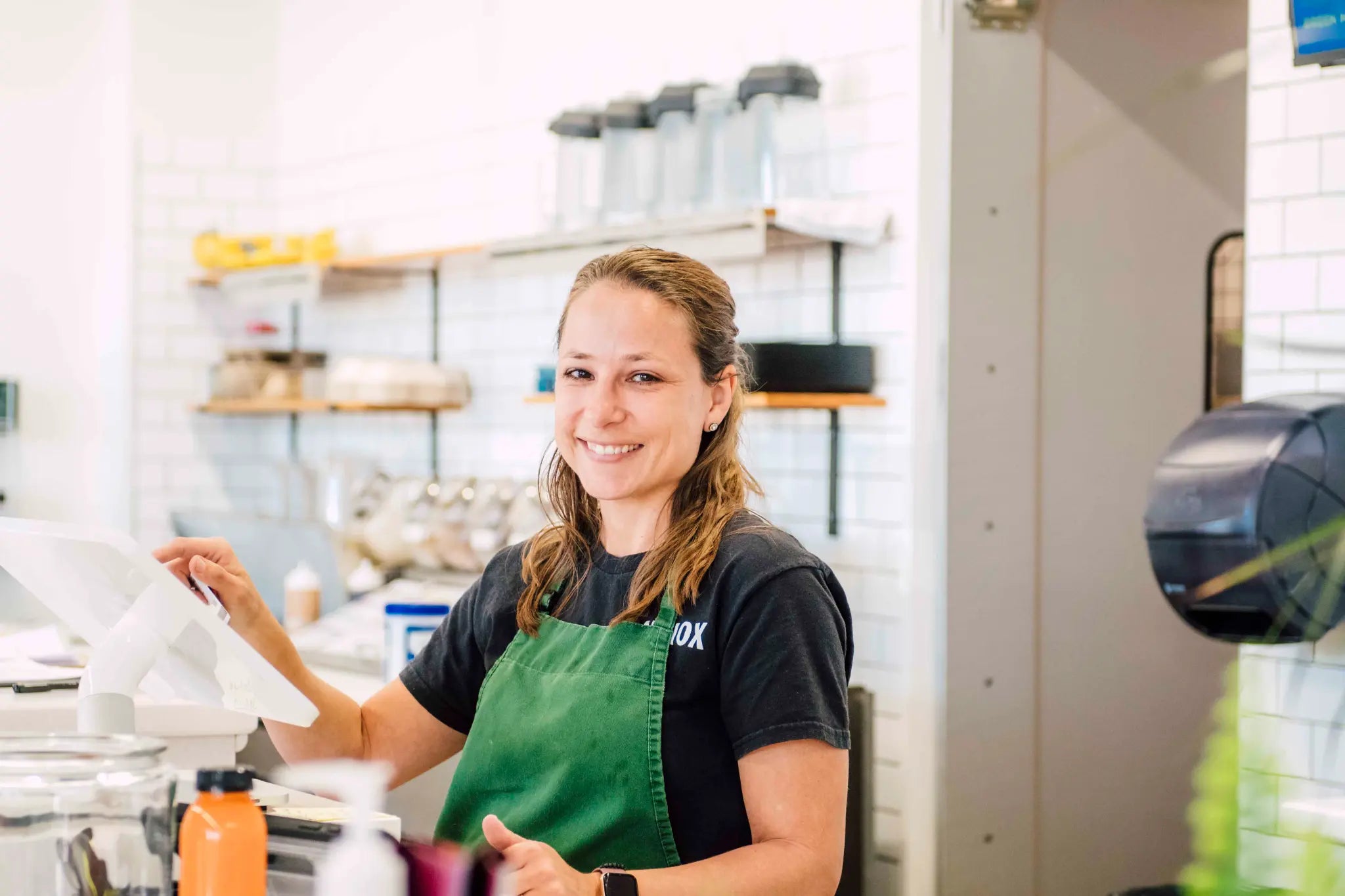A smiling ANTIOX juice-bar team member behind the Hagerstown counter