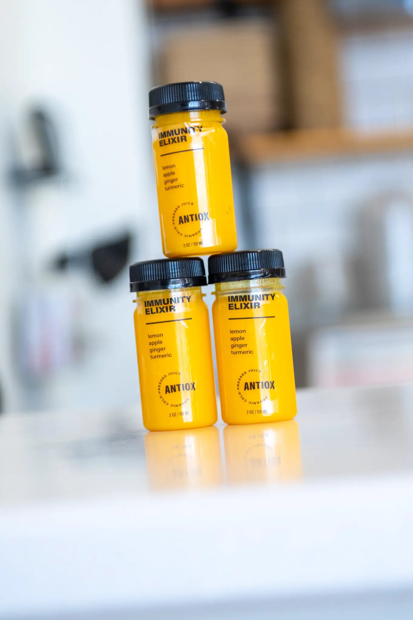 Yellow ANTIOX bottled shots displayed at the juice bar